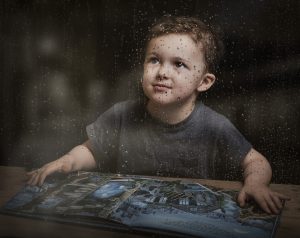 Boy day dreaming on a rainy day
