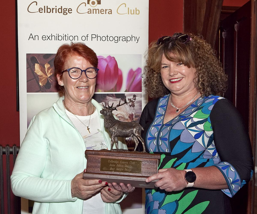 Marilyn Boyd being presented with the trophy for Best Overall Image in the Nature competition.